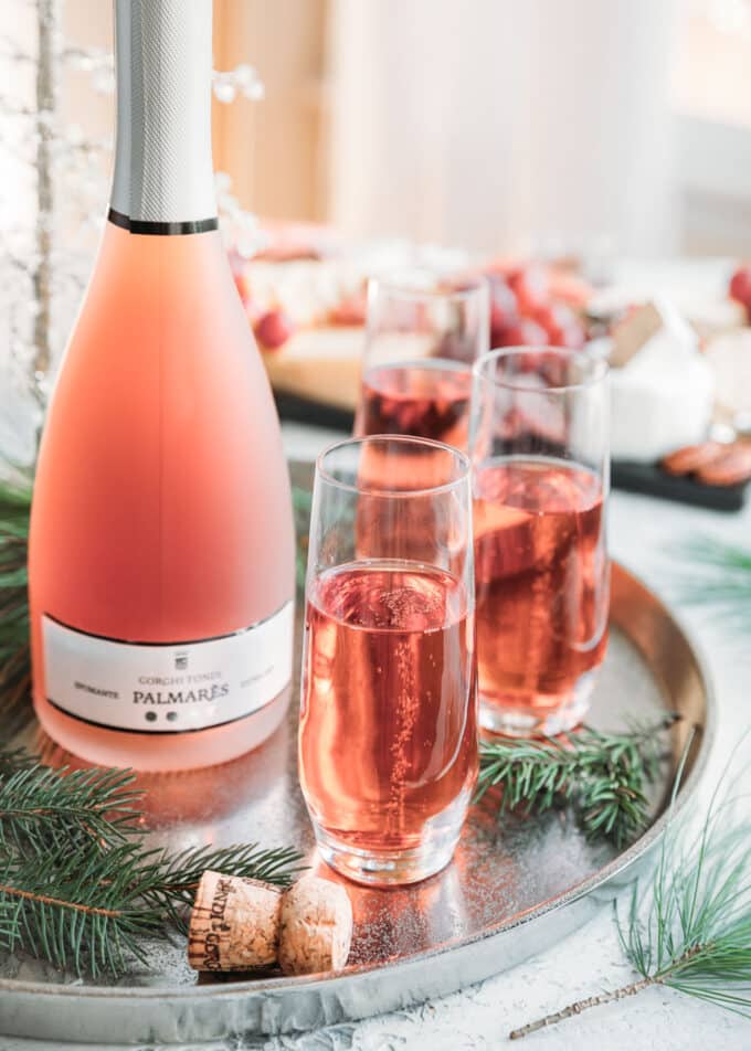 bottle of Gorghi Tondi Nero D’Avola ‘Palmares’ sparkling rose with three glasses poured on a silver platter