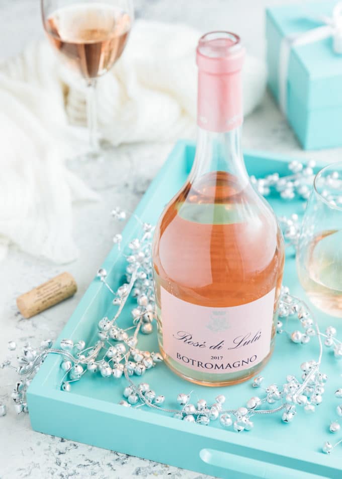 bottle of Botromagno ‘Rose di Lulu’ wine on a blue serving tray with silver bells