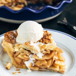 slice of homemade apple pie with a scoop of vanilla ice cream