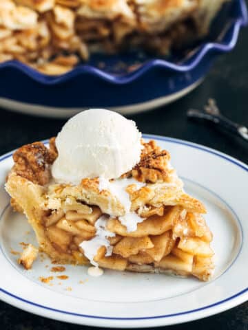 slice of homemade apple pie with a scoop of vanilla ice cream