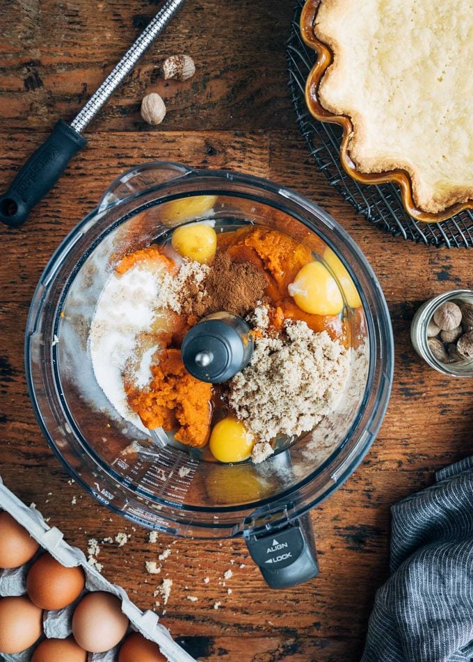 ingredients for pumpkin custard pie in a food processor bowl