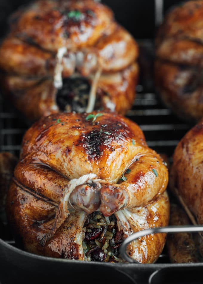 roasted cornish hen in a cast iron roasting pan