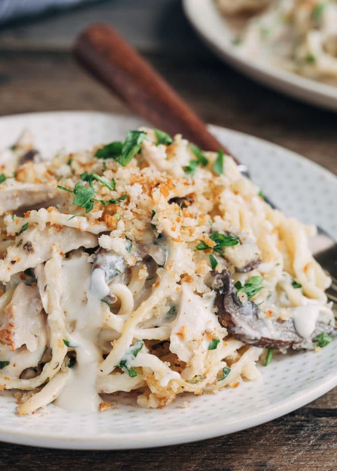 closeup of turkey tetrazzini on a plate with mushrooms and peas
