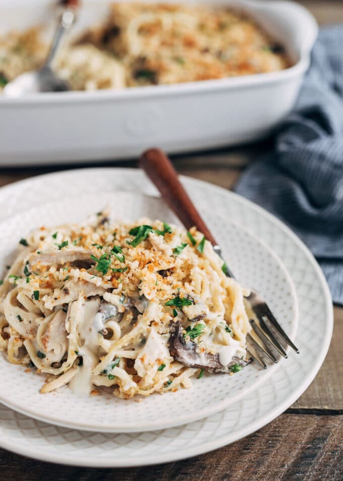 turkey tetrazzini on an ivory plate with a wood-handled fork