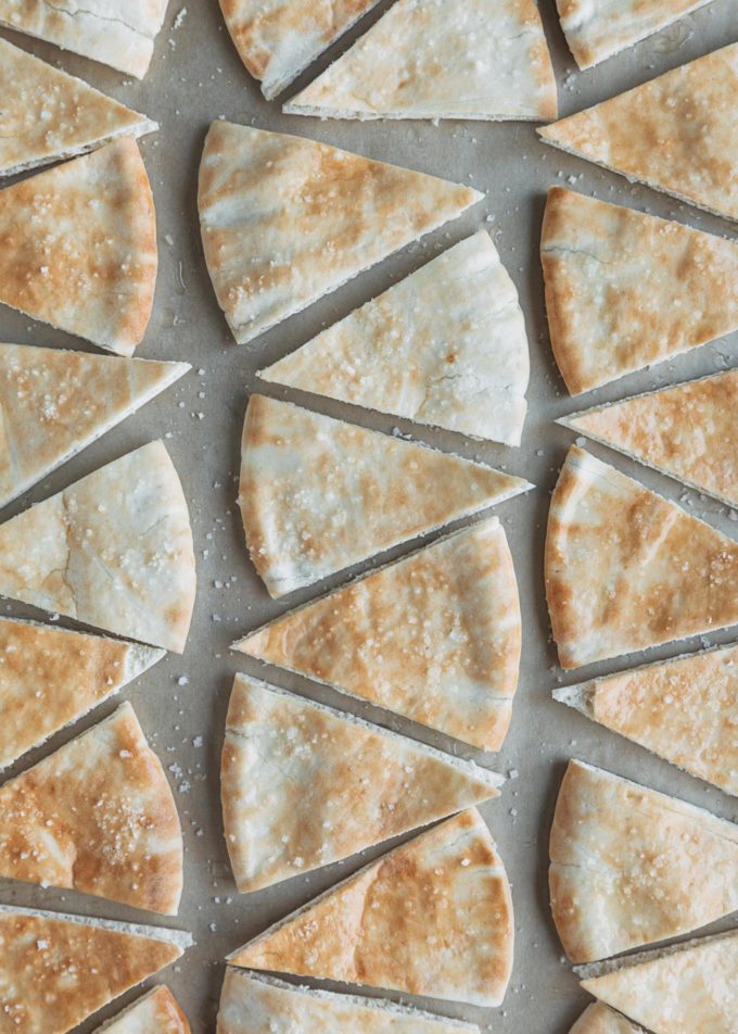 unbaked pita chips on a baking sheet with sea salt