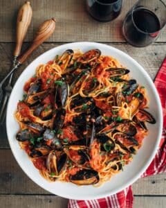 mussels with pasta and tomato sauce in a white serving bowl {sponsored}
