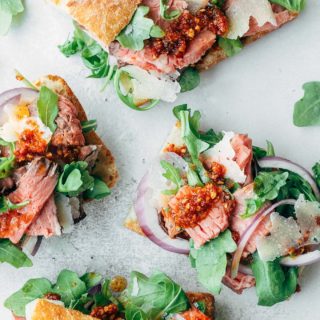 open faced roast beef sandwiches with baby arugula and pesto rosso