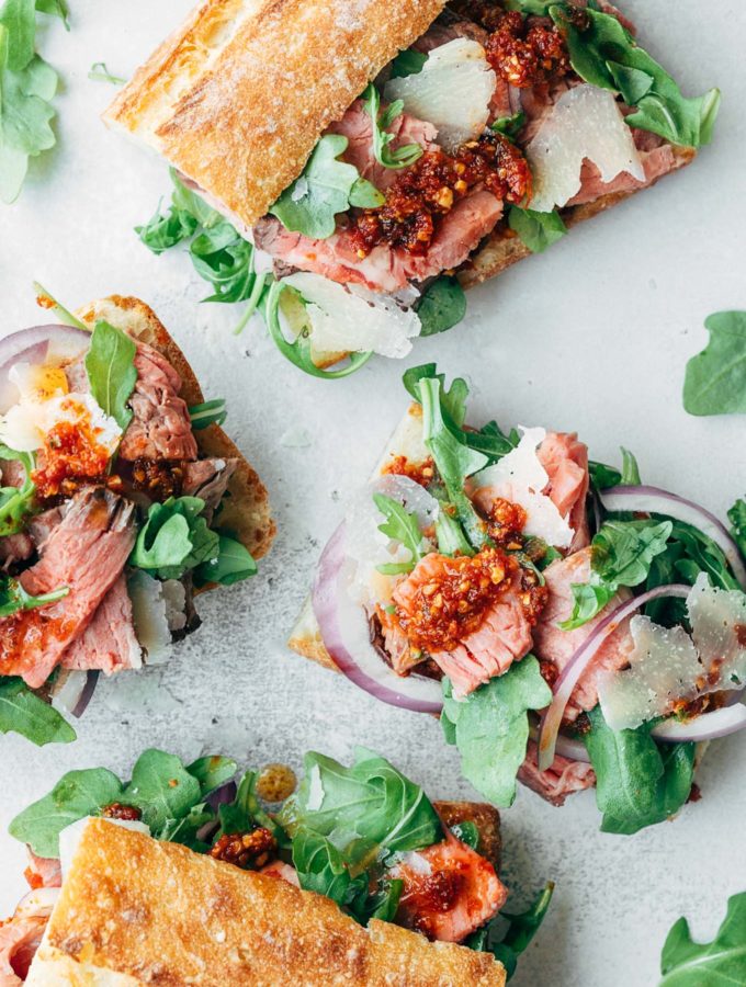 open faced roast beef sandwiches with baby arugula and pesto rosso