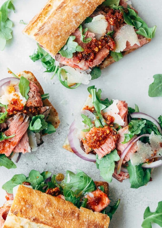 open faced roast beef sandwiches with baby arugula and pesto rosso