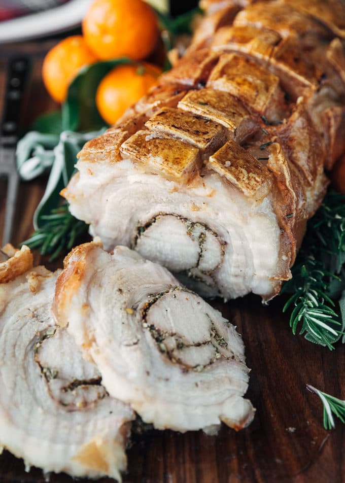 sliced porchetta roast on a carving board