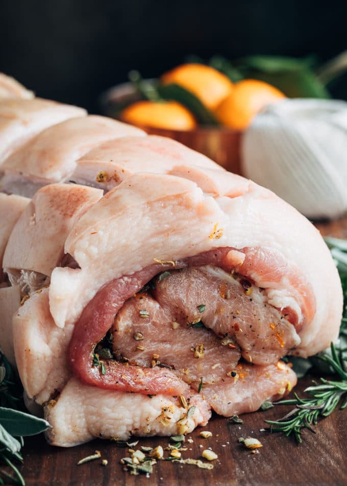 rolled raw porchetta on a board