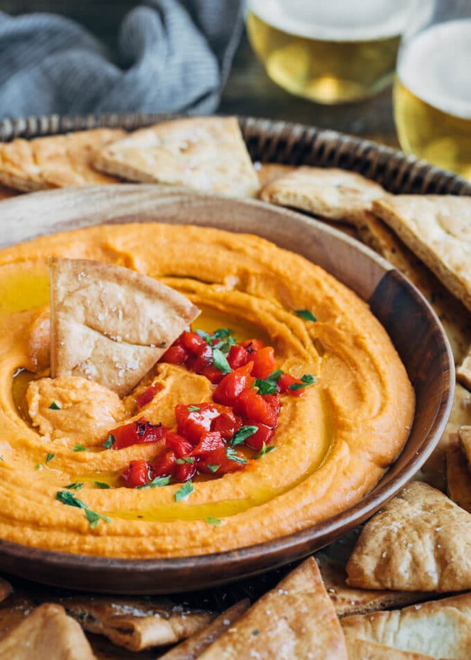 roasted red pepper hummus in a serving bowl with pita chips