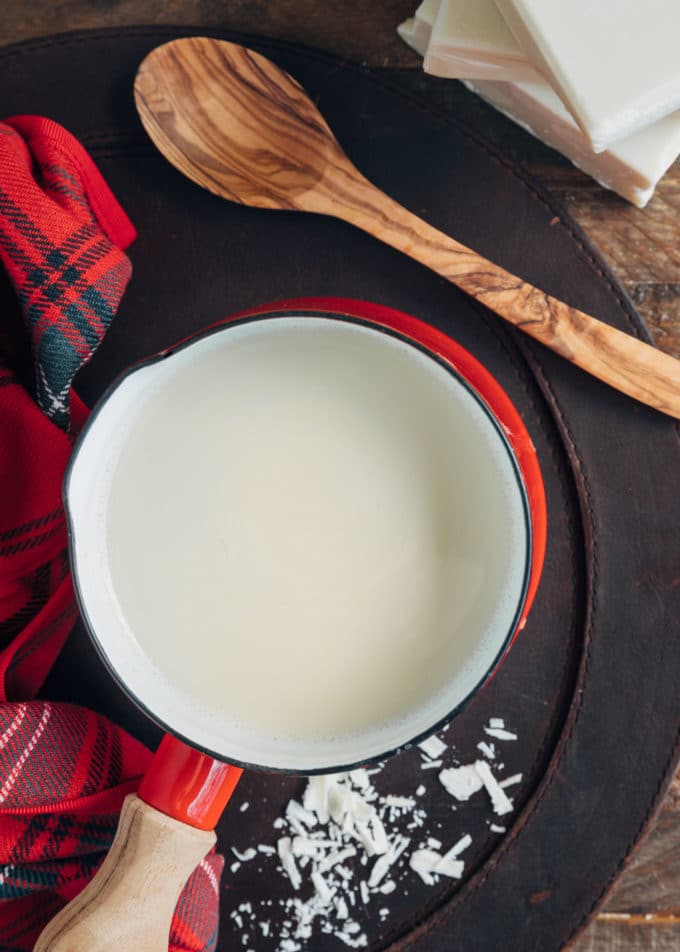 pot of white hot chocolate with a wood spoon