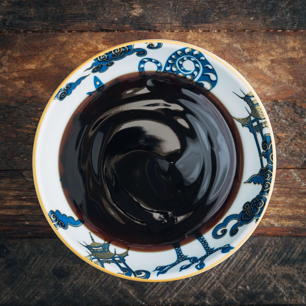 oyster sauce in a bowl on a wood board