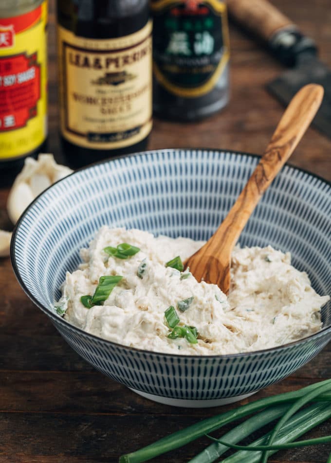 cream cheese and crab filling for crab rangoon in a blue striped bowl