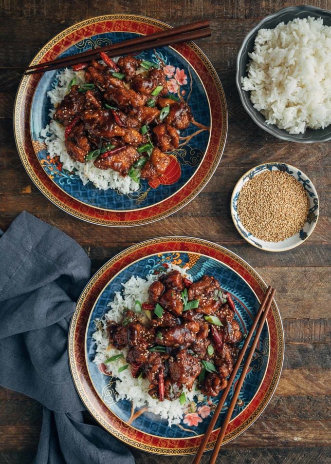 overhead of plates of General Tso's Chicken over white jasmine rice