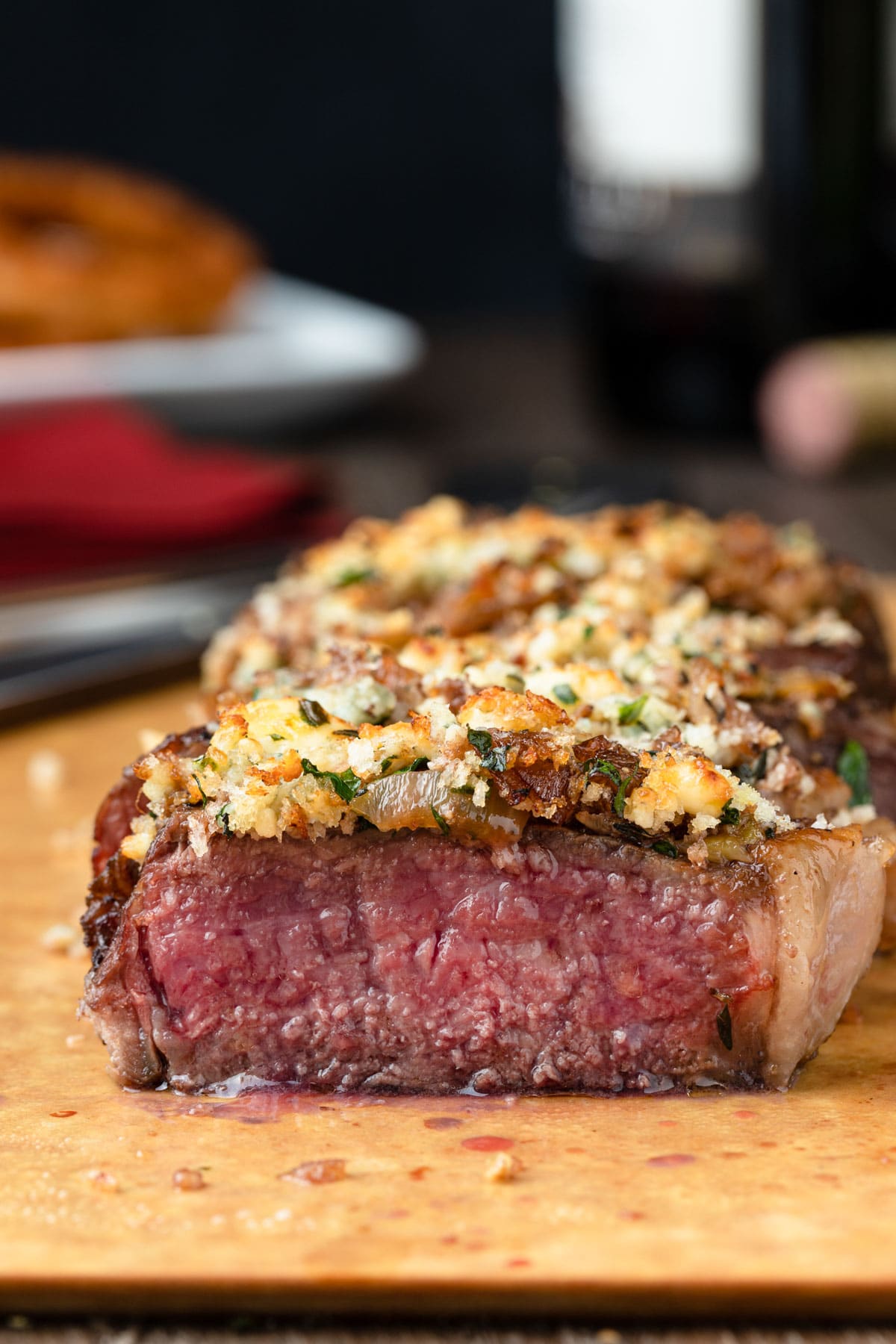 blue cheese crusted new york strip steak on a cutting board