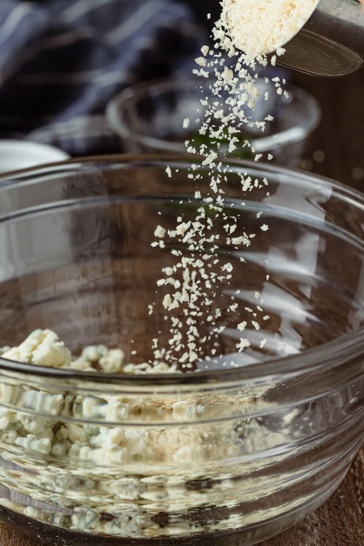 pouring panko breadcrumbs into a mixing bowl