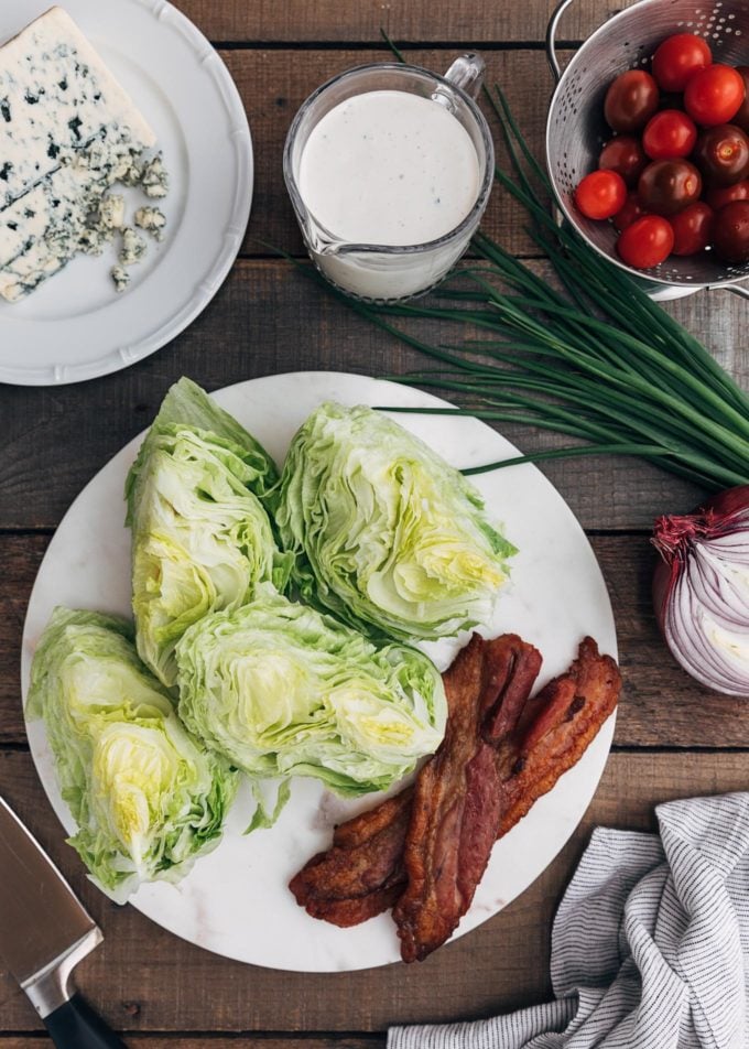 wedges of iceberg lettuce, blue cheese, and bacon for wedge salad