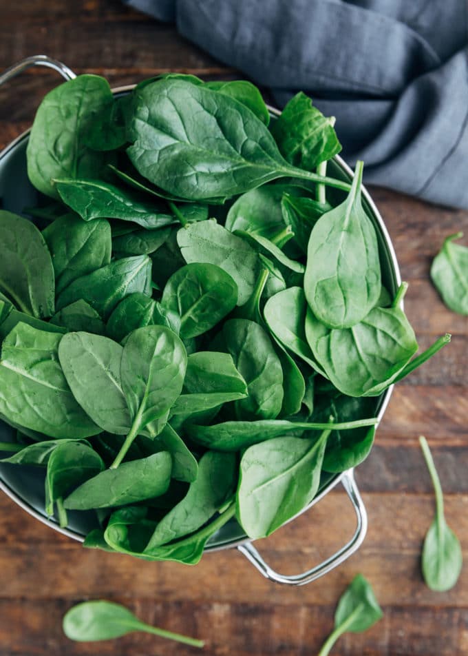 baby spinach leaves in a colander