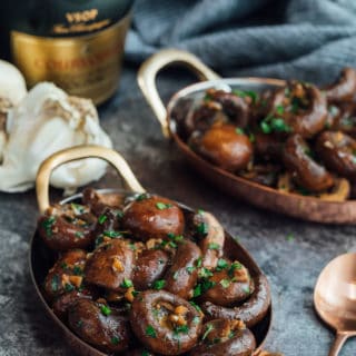 sauteed mushrooms with garlic and cognac in small copper gratin dishes