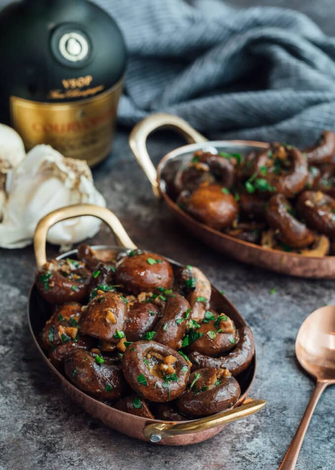 sauteed mushrooms with garlic and cognac in small copper gratin dishes