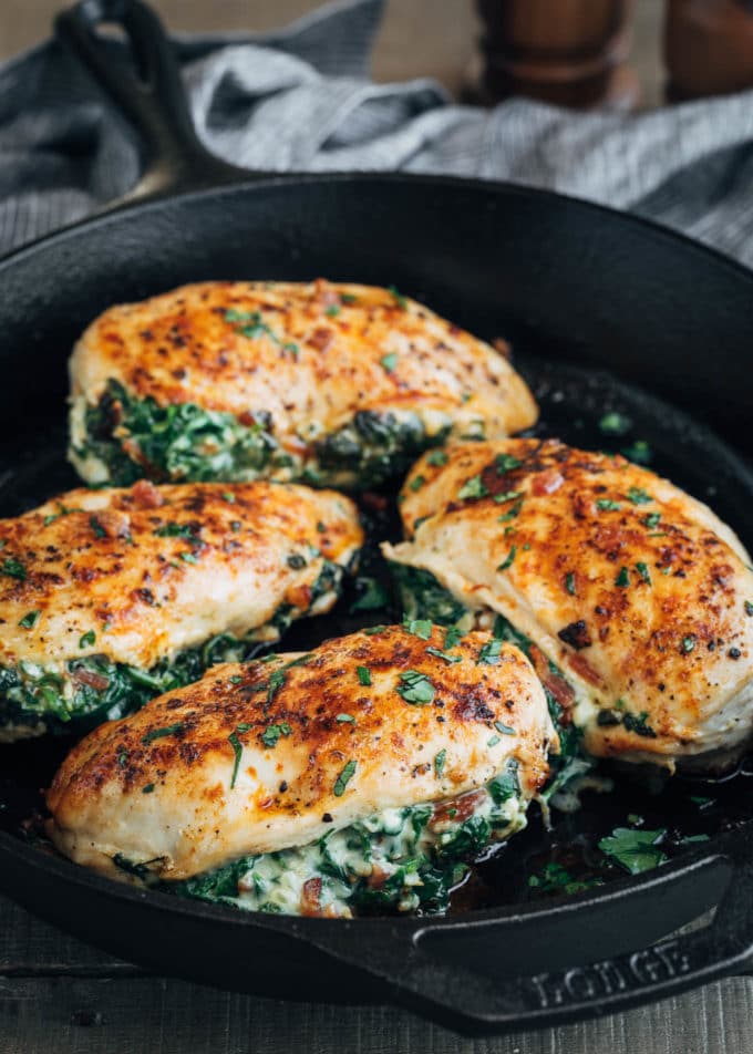 pan-roasted spinach and cheese stuffed chicken breasts in a cast iron pan