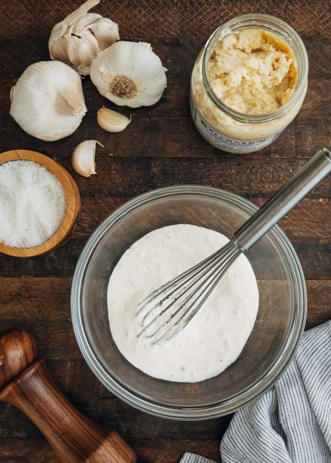 horseradish aioli in a bowl with a whisk