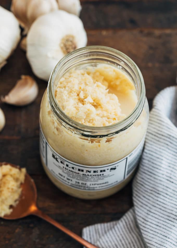 jar of prepared horseradish on a wood board