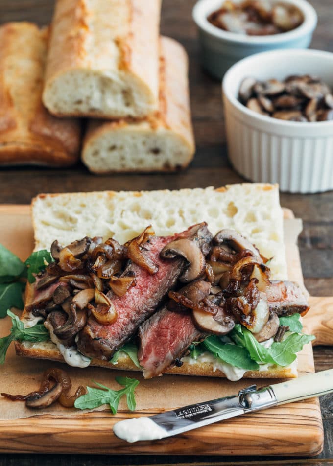 open faced steak sandwich with sautéed mushrooms and caramelized onions