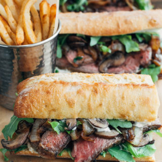 steak sandwiches with horseradish mayo on a wood board