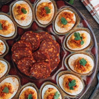 platter of chipotle deviled eggs with slices of chorizo sausage