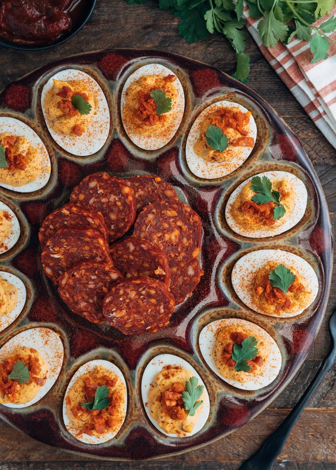 platter of chipotle deviled eggs with slices of chorizo sausage