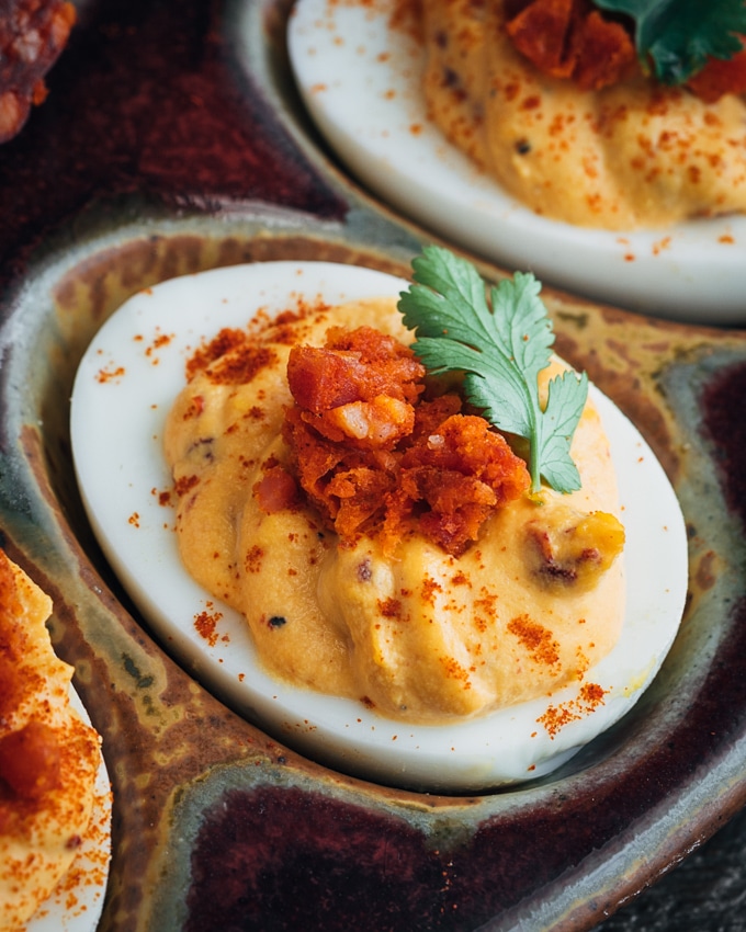 closeup of chipotle deviled eggs with minced chorizo and cilantro