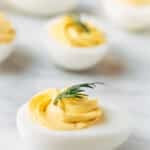 classic deviled eggs with dill on a marble board