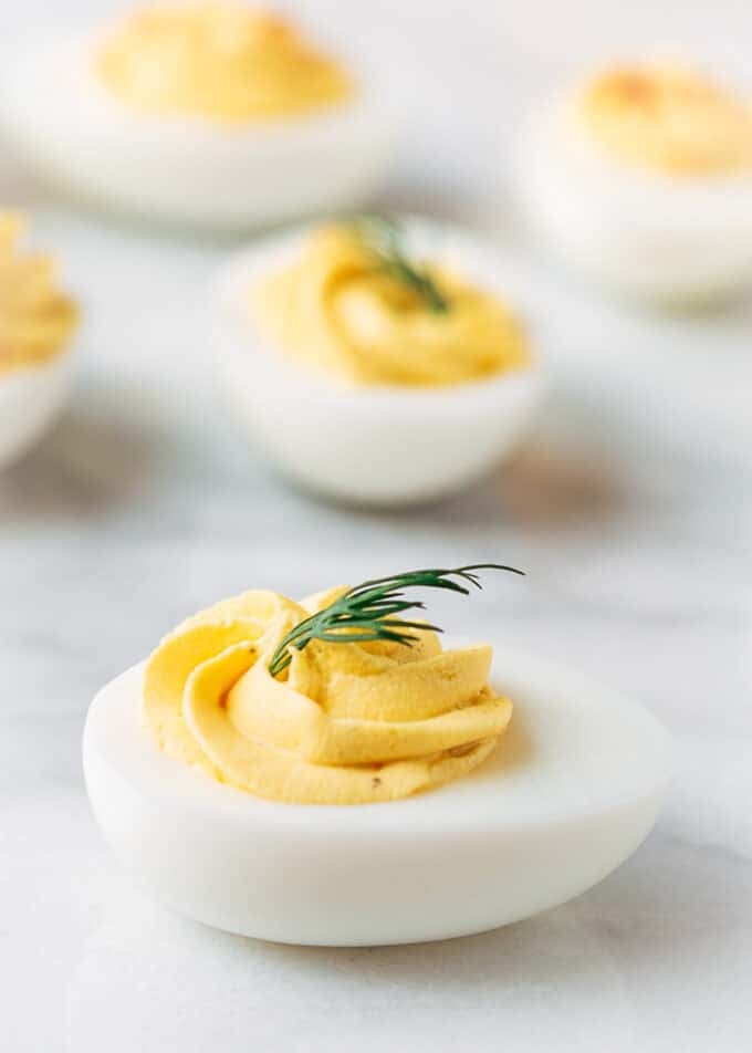 classic deviled eggs with dill on a marble board