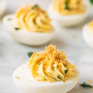 Italian deviled eggs on a white marble board