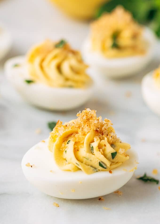 Italian deviled eggs on a white marble board