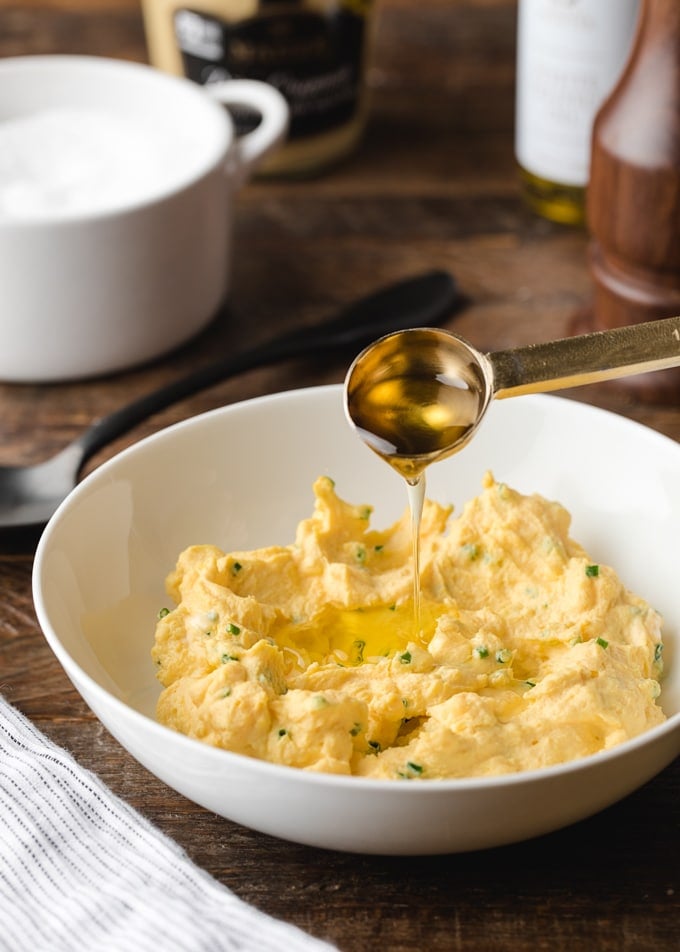 teaspoon measure drizzling truffle oil into a bowl of deviled egg filling