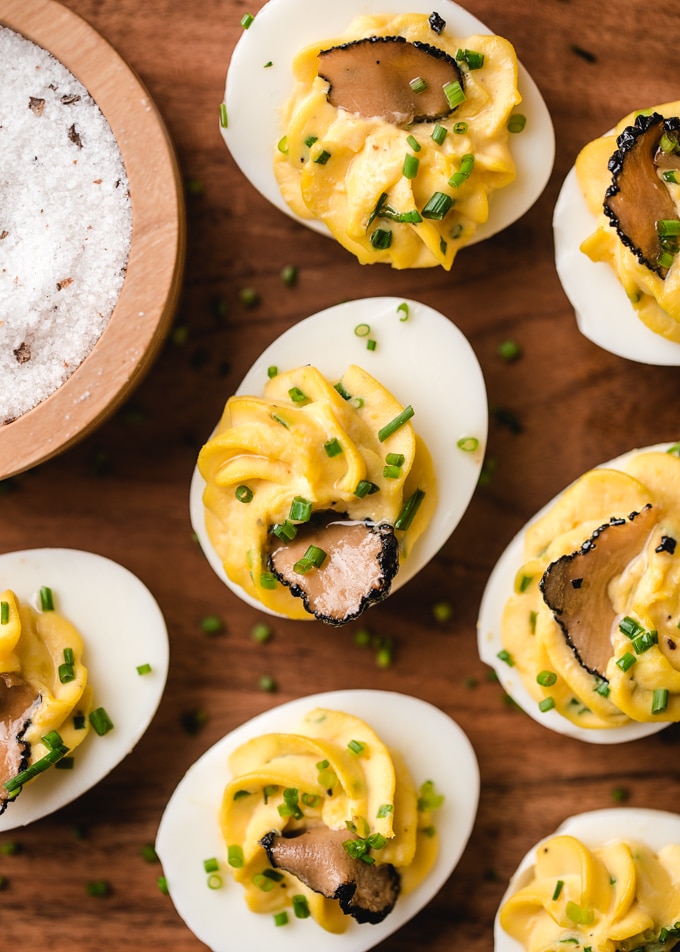 overhead of truffle oil deviled eggs with chives and shaved black truffles