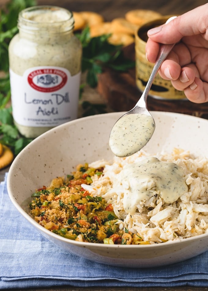 {sponsored} spoonful of Lemon Dill Aioli over a bowl of crab stuffing