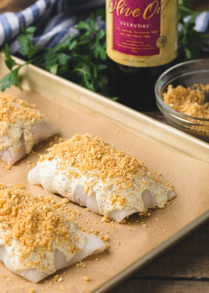 {sponsored} uncooked stuffed flounder bundles on a baking sheet