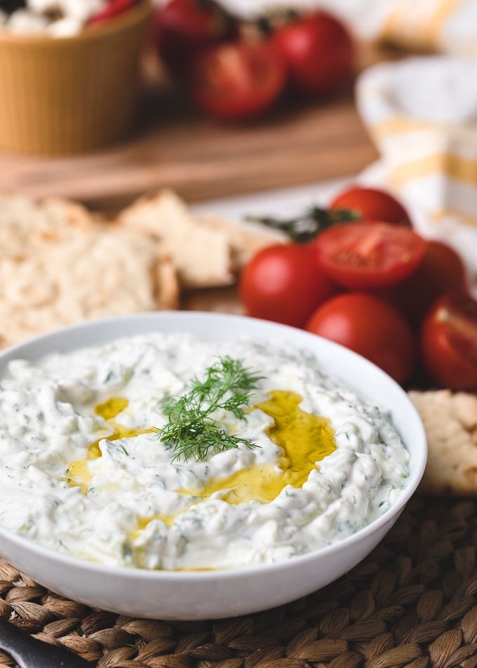 closeup of a bowl of homemade tzatziki sauce drizzled with olive oil