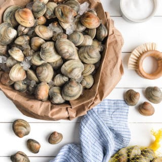 fresh clams on ice in a paper bag