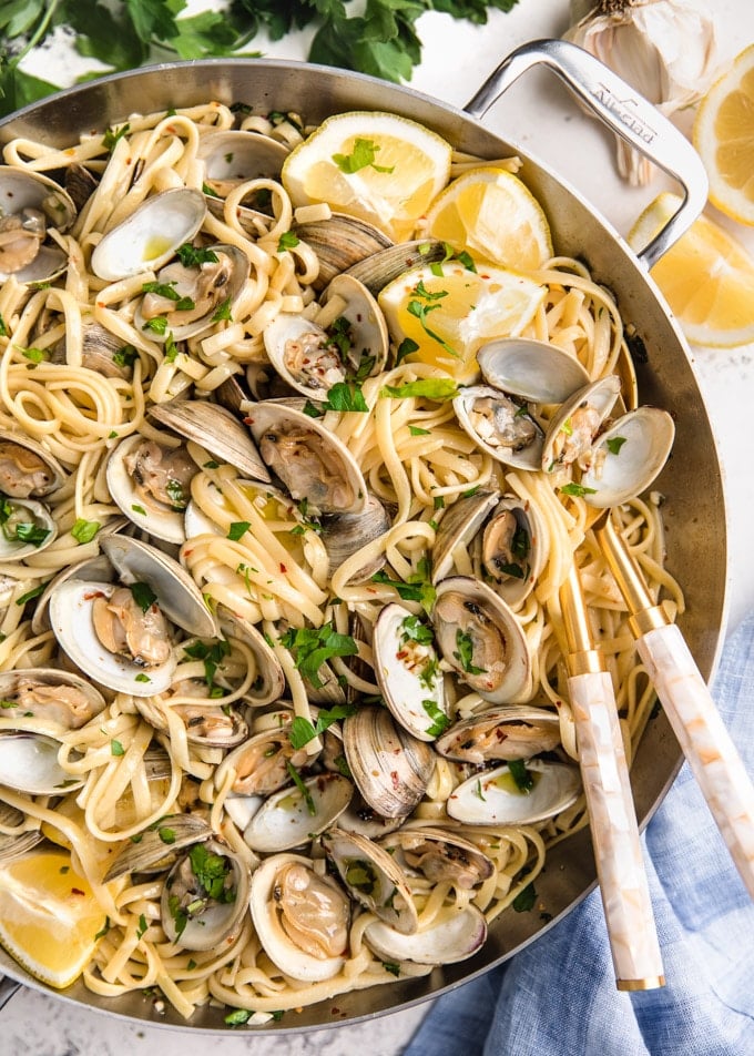 overhead of linguine with clams in a stainless steel pan