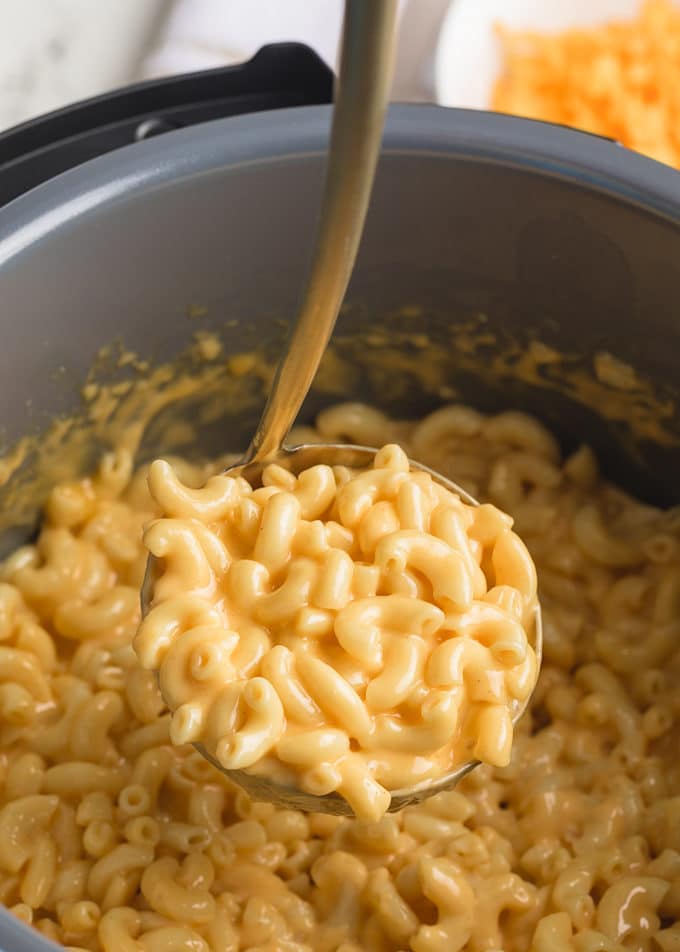 ladleful of creamy mac and cheese in an instant pot