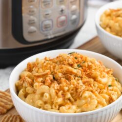 instant pot macaroni and cheese in a white bowl with crushed cheese crisps