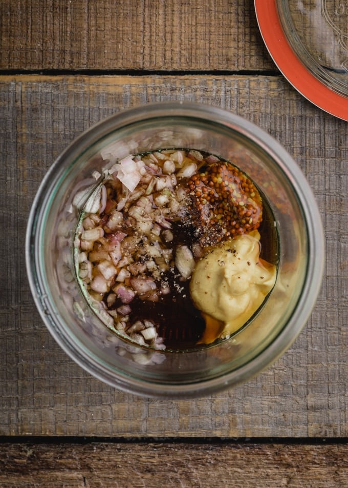 ingredients for maple dijon vinaigrette in a glass Weck jar