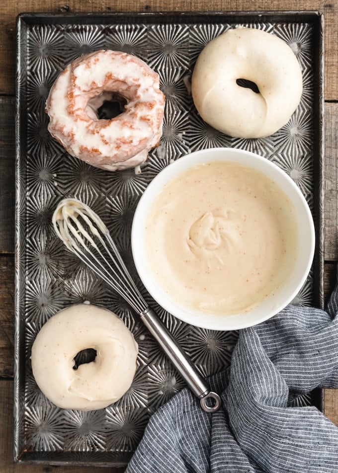 doughnuts dipped in brown butter blaze on a vintage baking tin