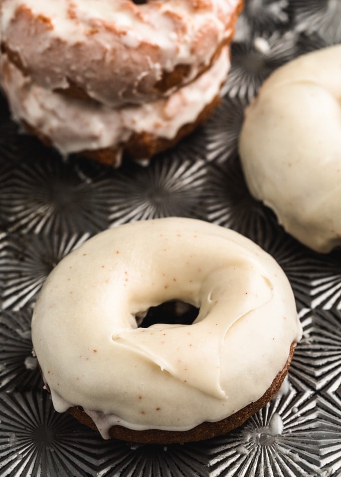 closeup of pumpkin doughnuts dipped in brown butter glaze